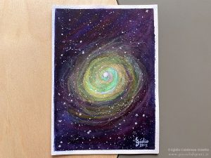 Dipinto ad acquerello su carta di 12,6x17,7 dove, attraverso trasparenze di colori, è raffigurata un'immaginaria nebulosa.